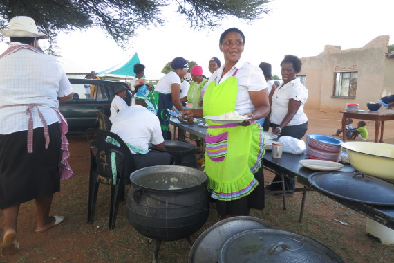 Using their own savings, Mafikeng group members prepare a meal for all members at the Network meeting