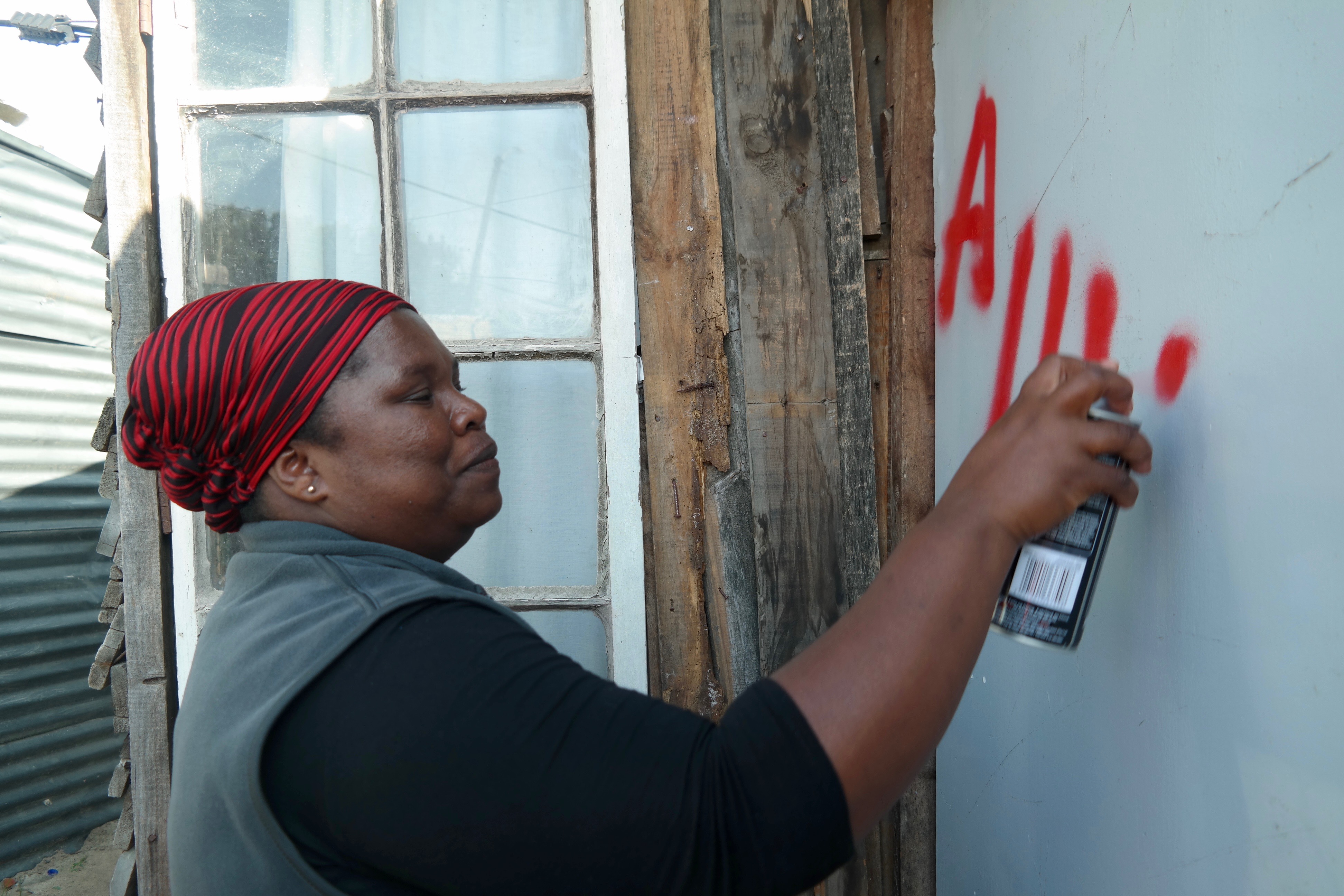 Each shack in the community is spray-painted with a number. In this case, the number is preceded by "A" to refer to the section of the settlement, given Kosovo's large size.