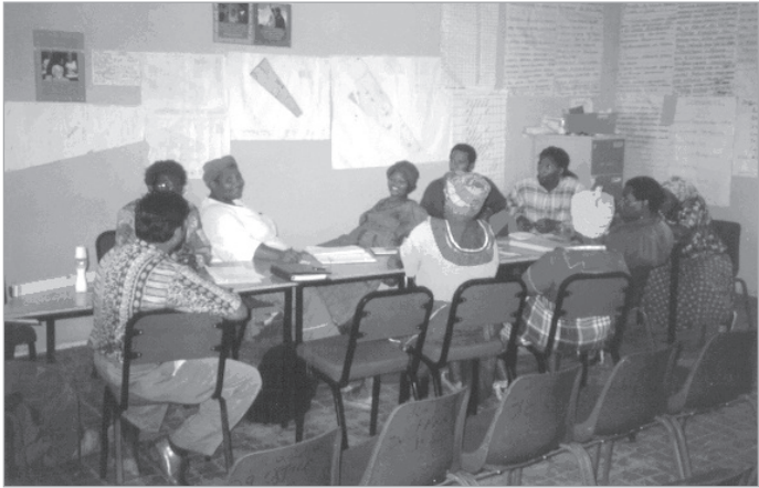 The Joe Slovo community meets in 1997. Pictured in the white shirt on the left is community leader Evelyn Benekane.